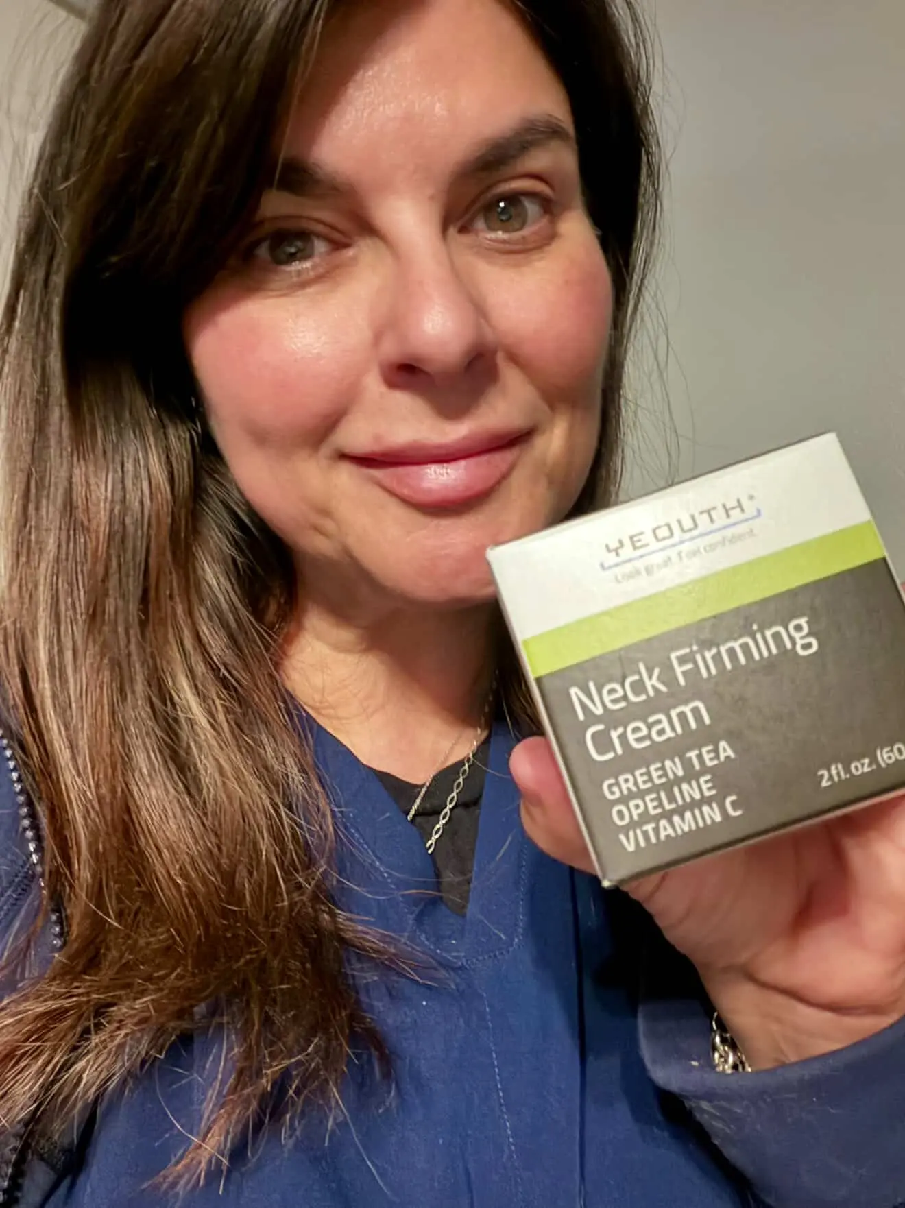 Customer showcasing Neck Firming Cream results